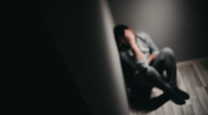 sad person sitting in a corner upset